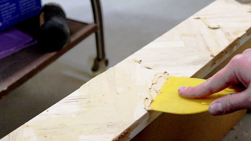 Filling in gaps between popsicle sticks with wood filler
