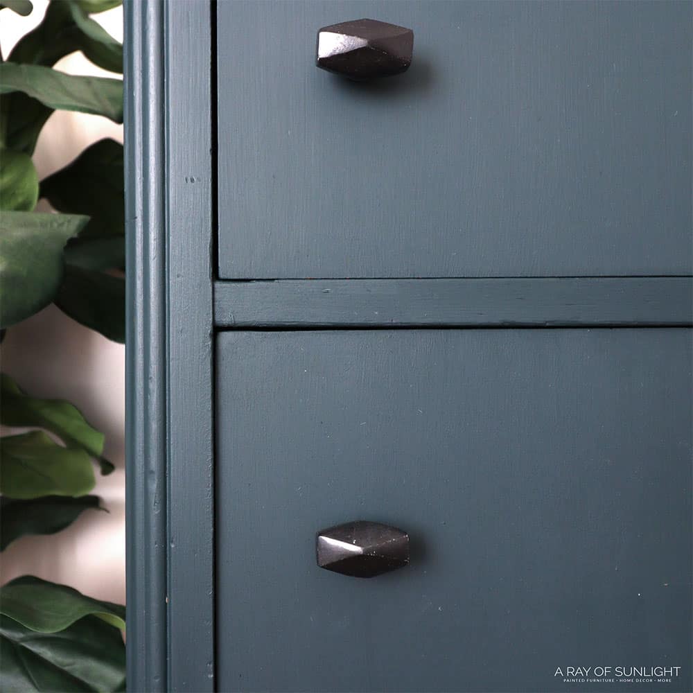closeup of the dresser drawers and goemetric black knobs