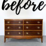 A wooden dresser with six drawers and brass handles, with the word before written above it.