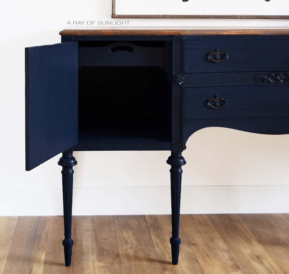 closeup of the blue antiqued buffet with a cabinet door open