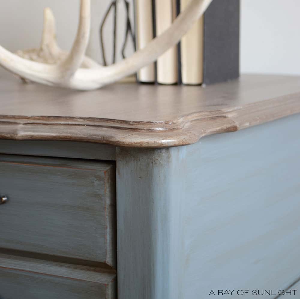 closeup of blue painted nightstand with distressing on the edges