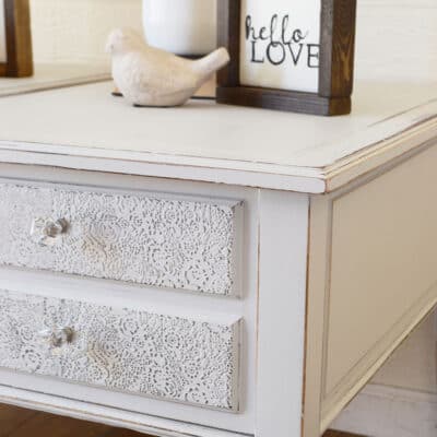 light gray painted end table with lace raised stenciling
