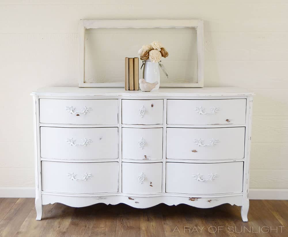 white painted french dresser with heavy distressing from power sander
