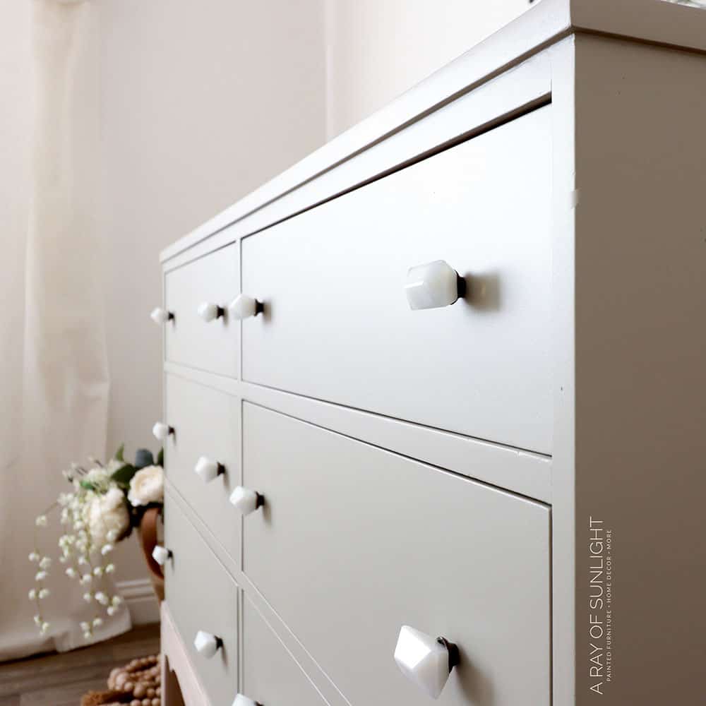 Side view of finished DIY dresser makeover with Melange ONE Knapsack paint and white knobs