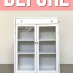 White cabinet with glass doors and shelves, against a plain wall, with BEFORE text above in bold letters.
