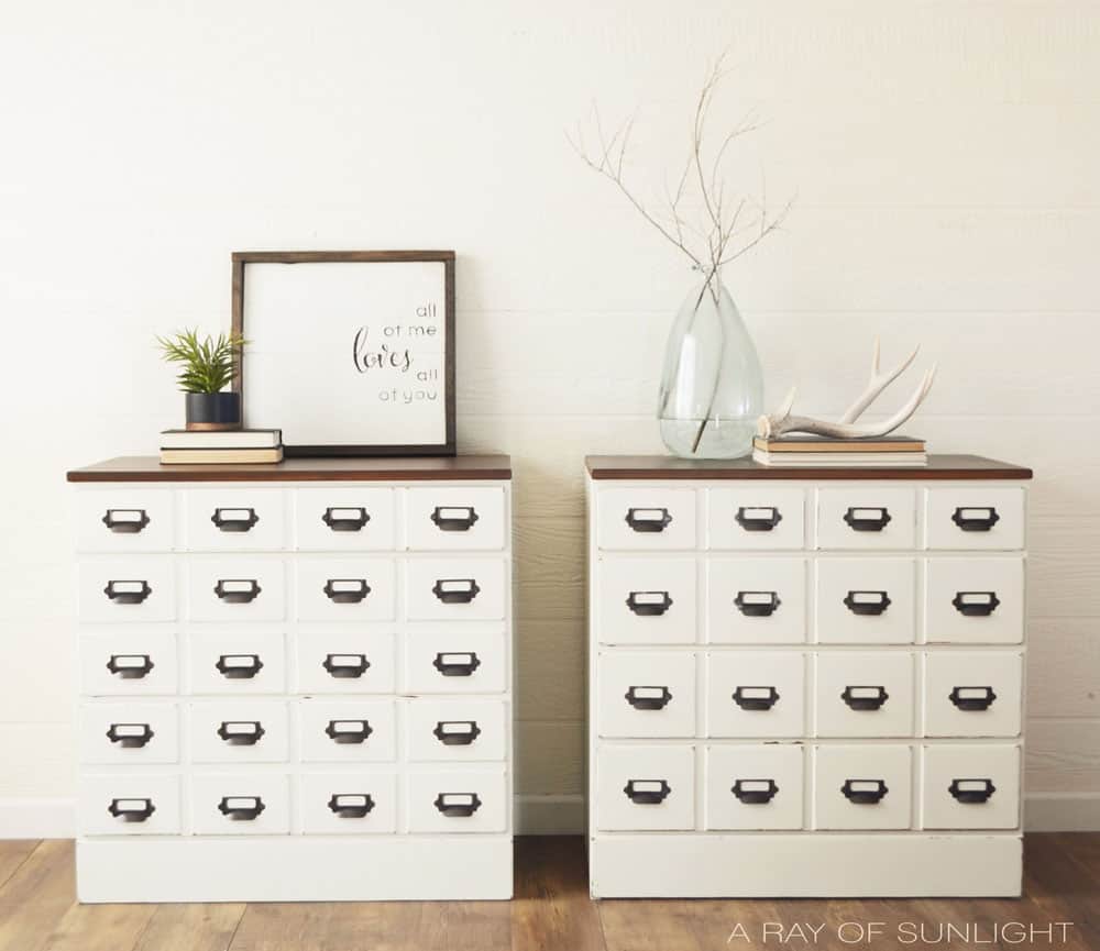 Full view of white card catalog dressers and stained wood tops.