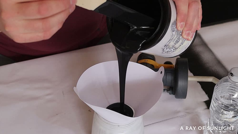 Pouring Heirloom Traditions All-In-One Paint through a paint filter.