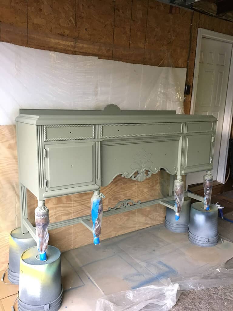 antique buffet painted in olive green paint - in progess