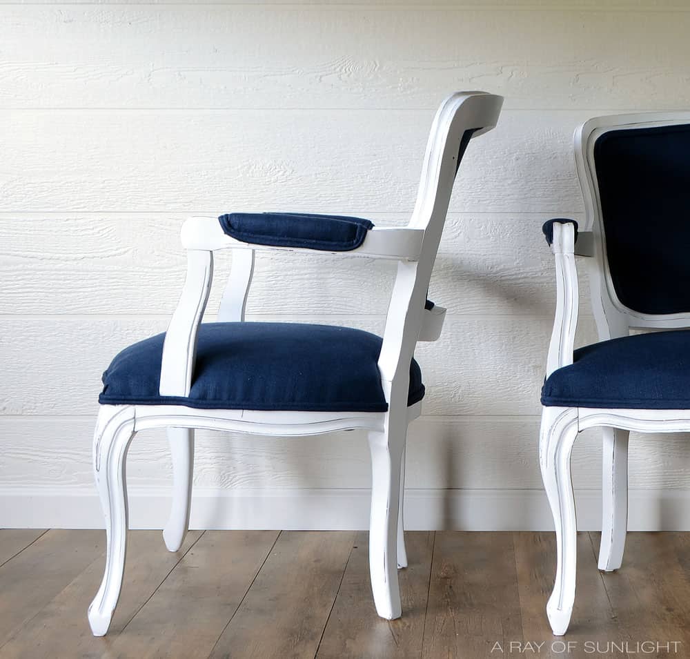 white painted chairs with blue upholstery 