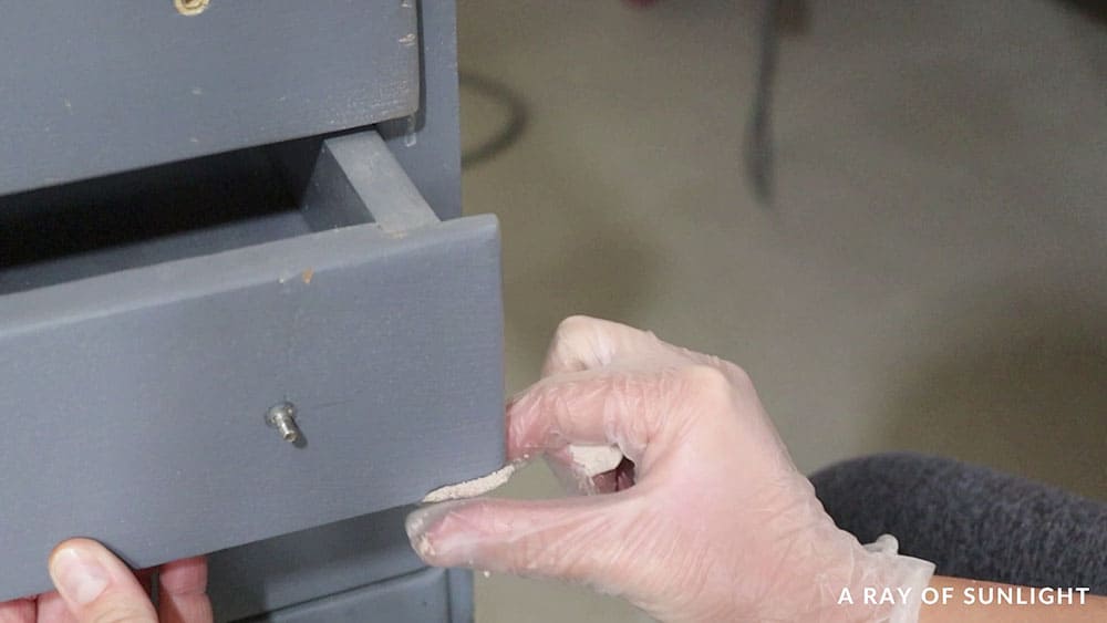 Repairing a chipped corner on a drawer front with KwikWood.