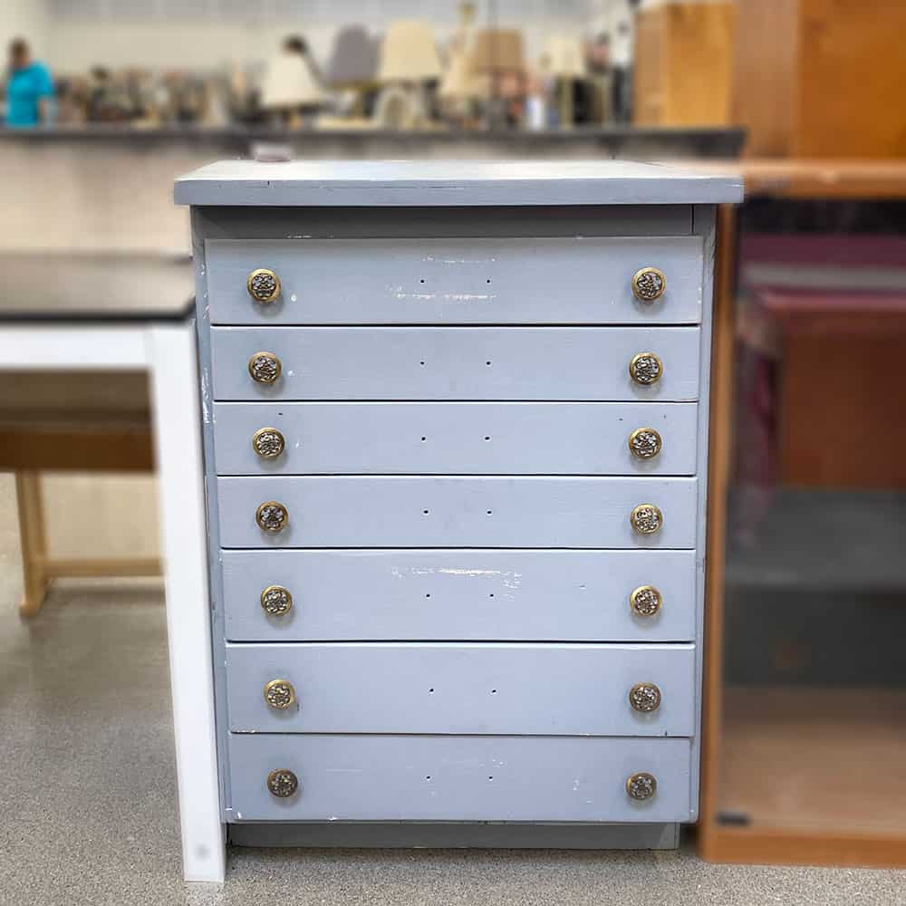 Homemade flat file cabinet with an old beat up grey paint job.