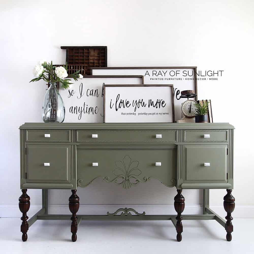 olive green painted antique buffet with white knobs and stained legs