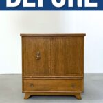 A small wooden cedar chest with two doors and a drawer