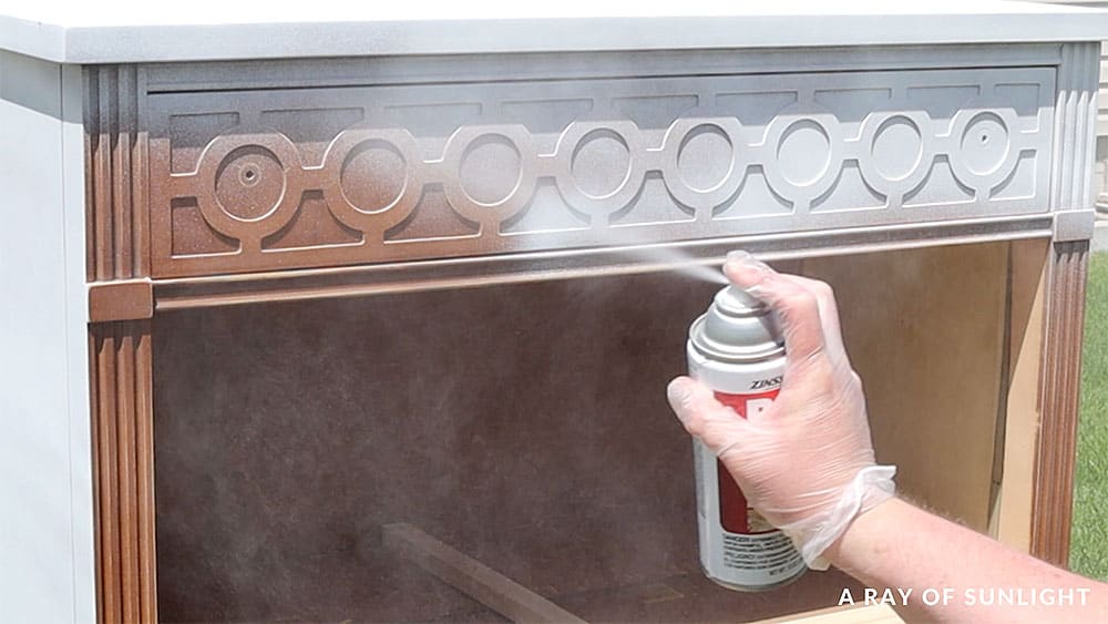 Spraying a dresser with BIN Shellac Based Primer