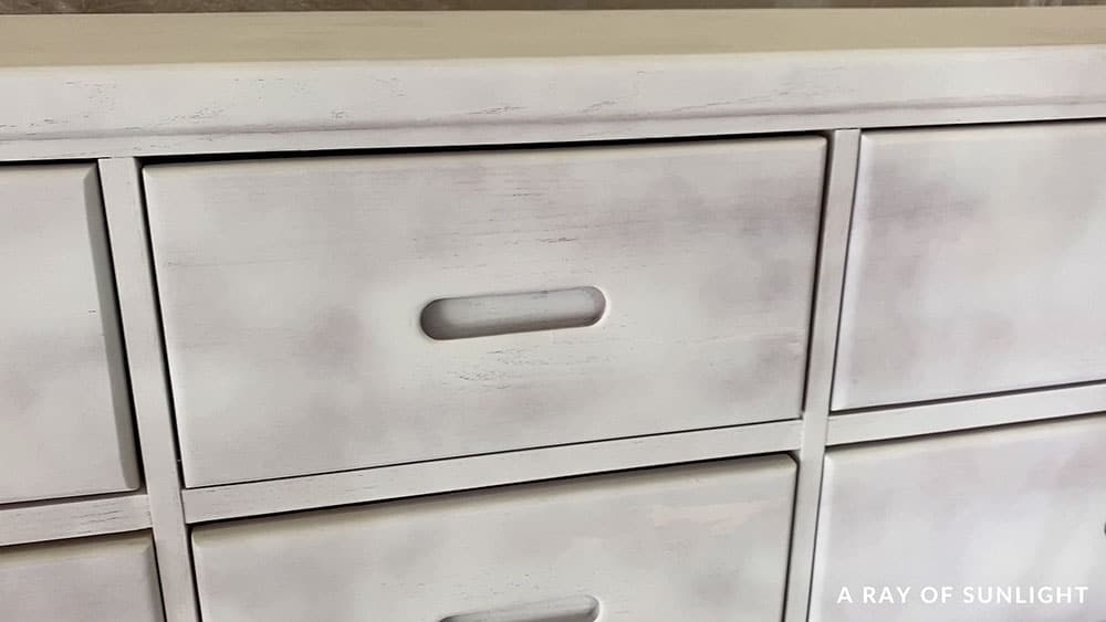 closeup of primed dresser with oak wood grain showing