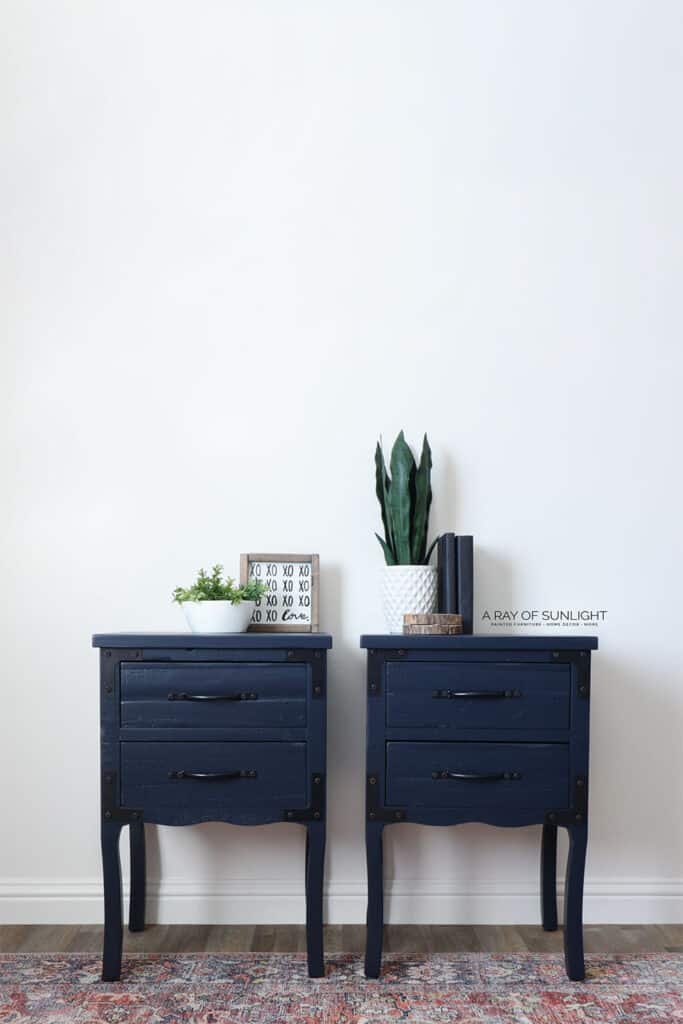Full view of rustic nightstands painted  in a dark navy blue latex paint.