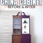 A china cabinet painted purple stands by a garage door, featuring before & after text above it.