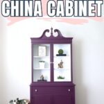 Purple china cabinet with glass doors and white shelves