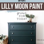 Dark green painted dresser with silver knobs, plant, and basket, with text about painting furniture with Lilly Moon Paint.