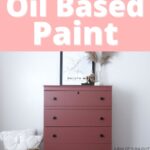 A red painted dresser with black knobs