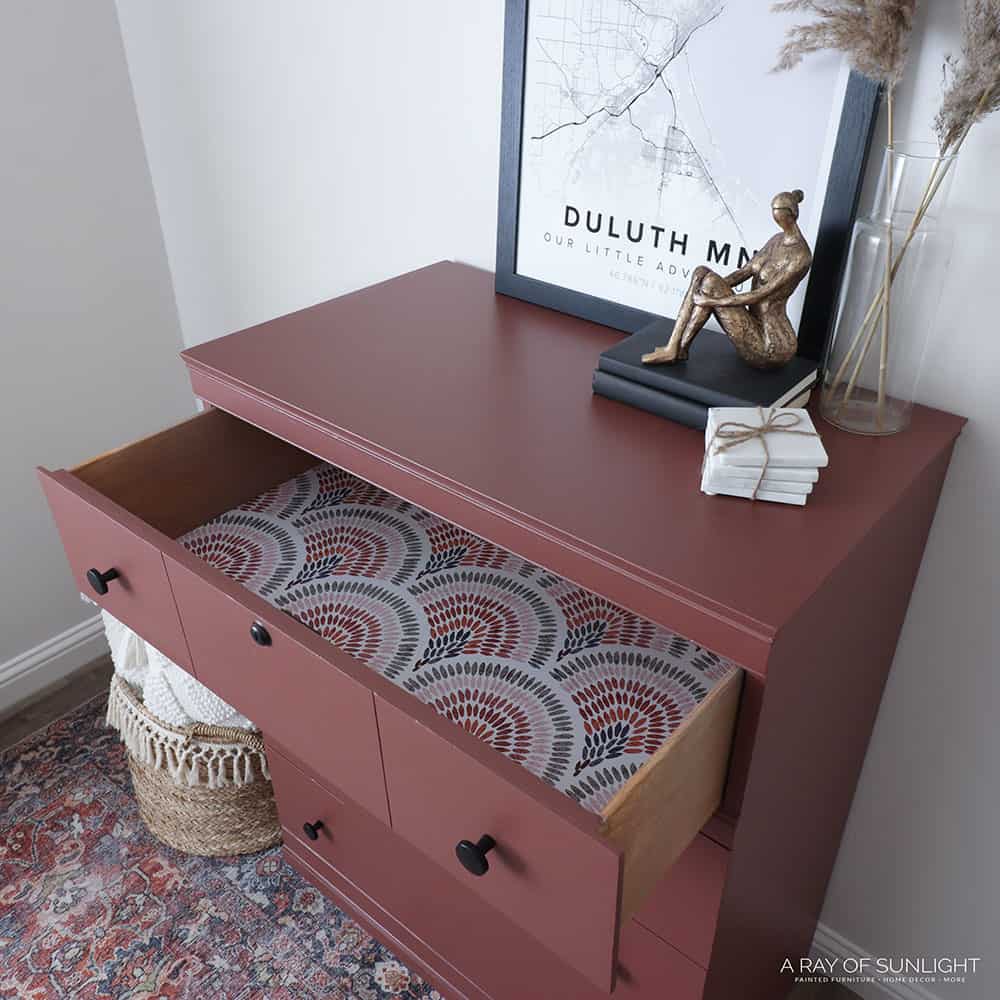 rust painted dresser with open drawer
