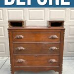 Old wooden dresser with ornate handles and cubby holes, standing outside in front of a garage door. BEFORE text above.