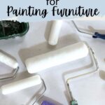 Several paint rollers of different sizes and colors are spread out on a white surface.