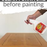 A hand sprays cleaner onto a wooden table, with text: How to clean furniture before painting.