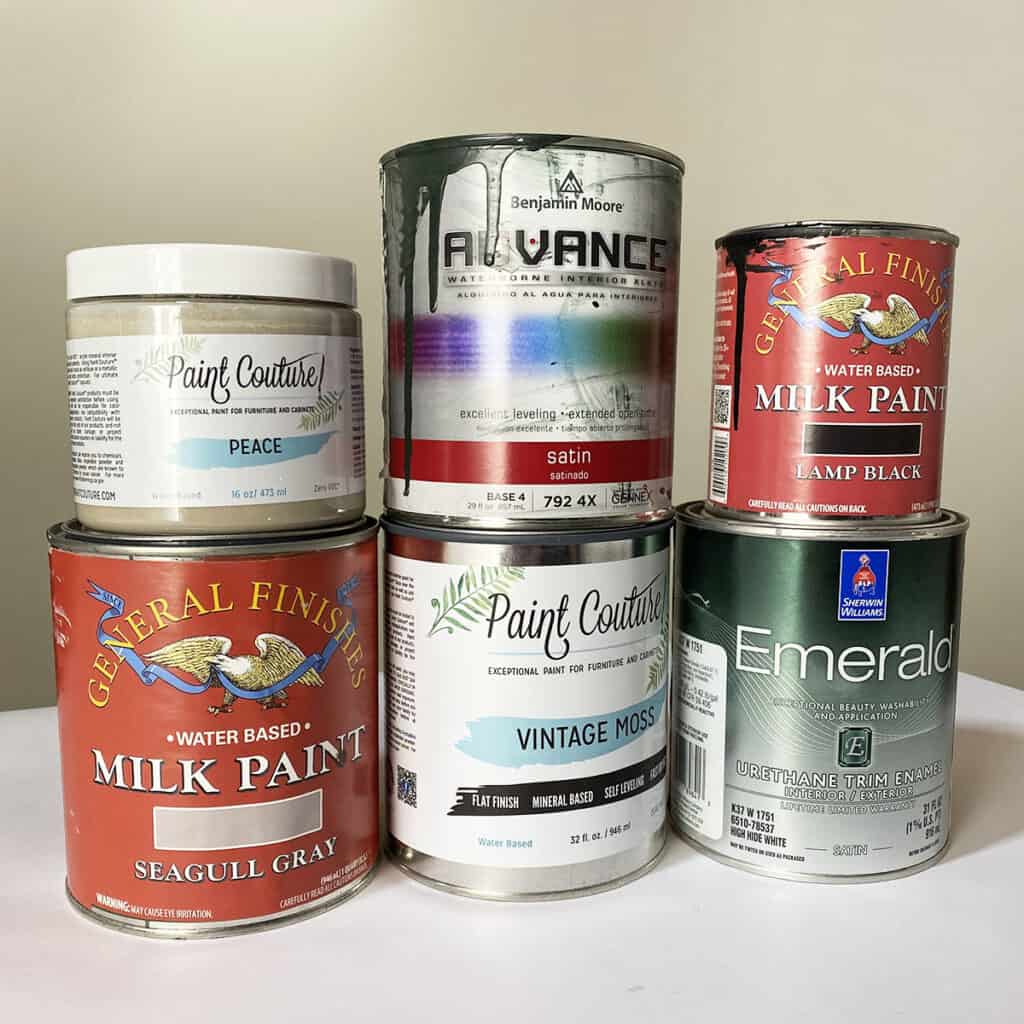 different self leveling paints in cans stacked