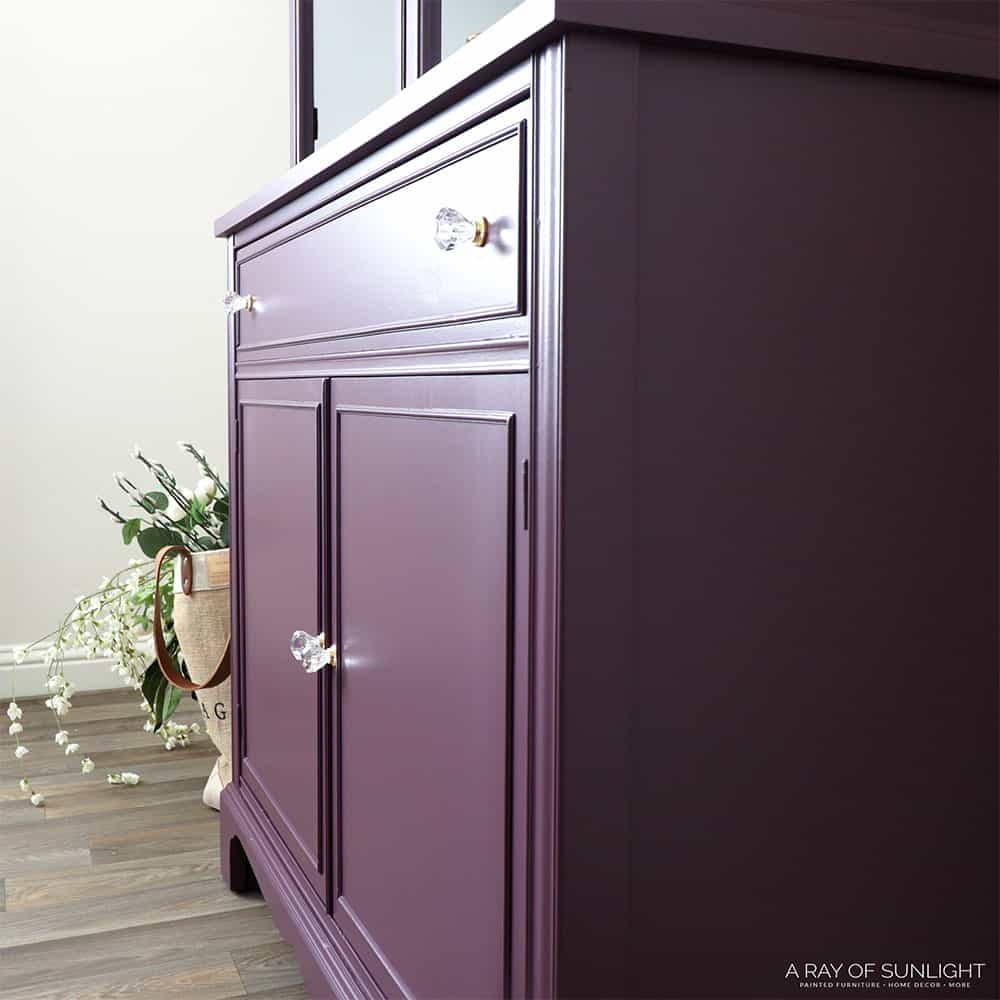side view of purple painted china cabinet with diamond cut knobs