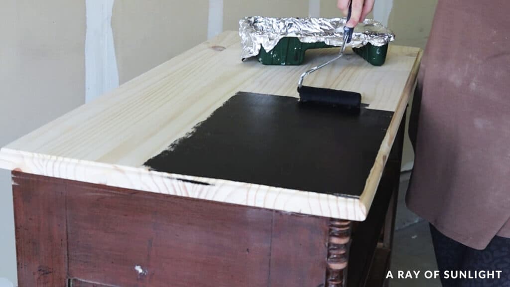 painting dresser top with a paint roller