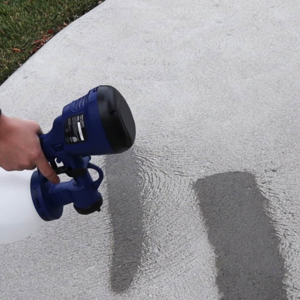 spraying water through paint sprayer