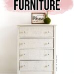 White dresser with embossed drawer fronts and crystal clear knobs
