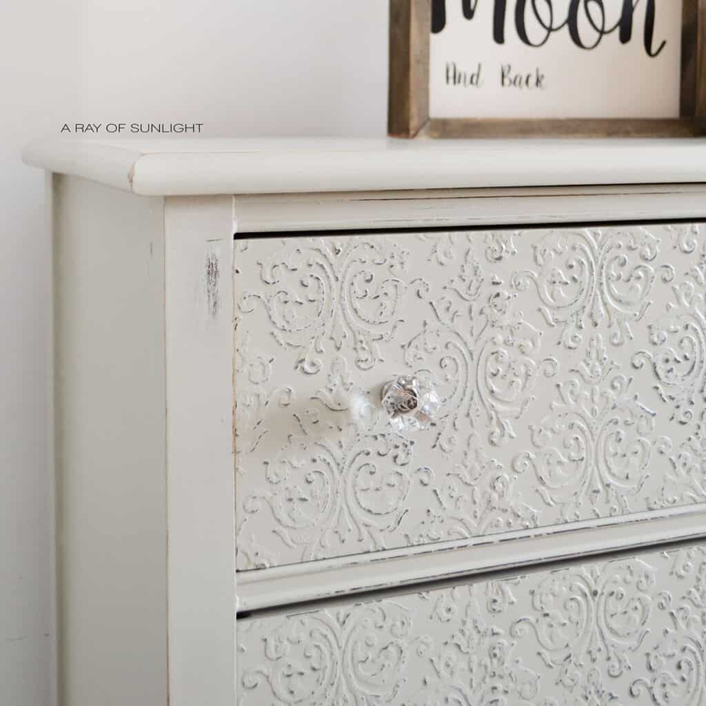 closeup of damask embossed drawer with glass knob