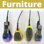 Four electric sanders lined up on a white surface