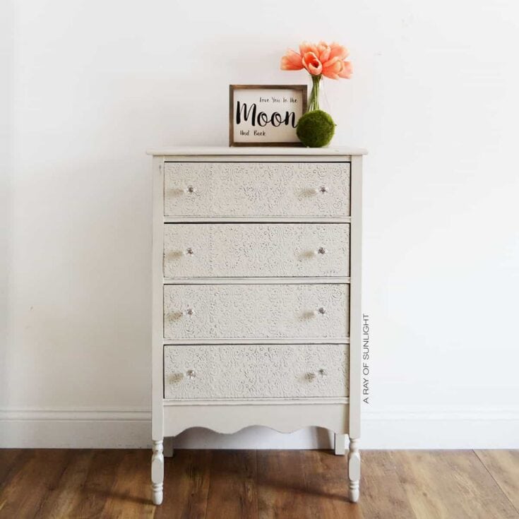chest of drawers after painting grey and embossing