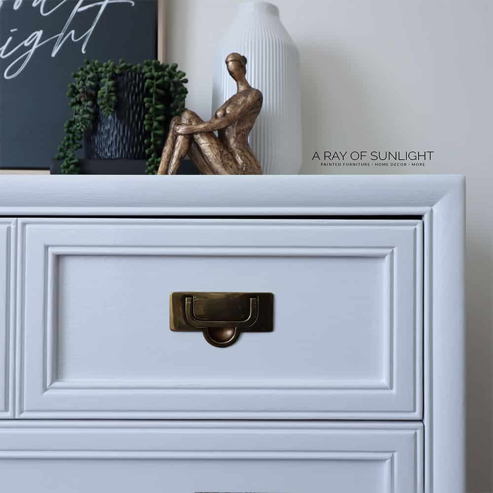 close up photo of dresser painted with white high gloss paint