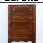 A tall, old wooden dresser with four drawers
