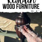 Gloved hand applying stain to a dark wood furniture leg; text reads How to Restain Wood Furniture.