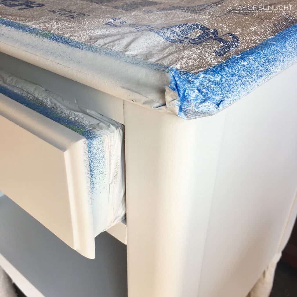 plastic and tape protecting the top and inside of drawer while spraying paint