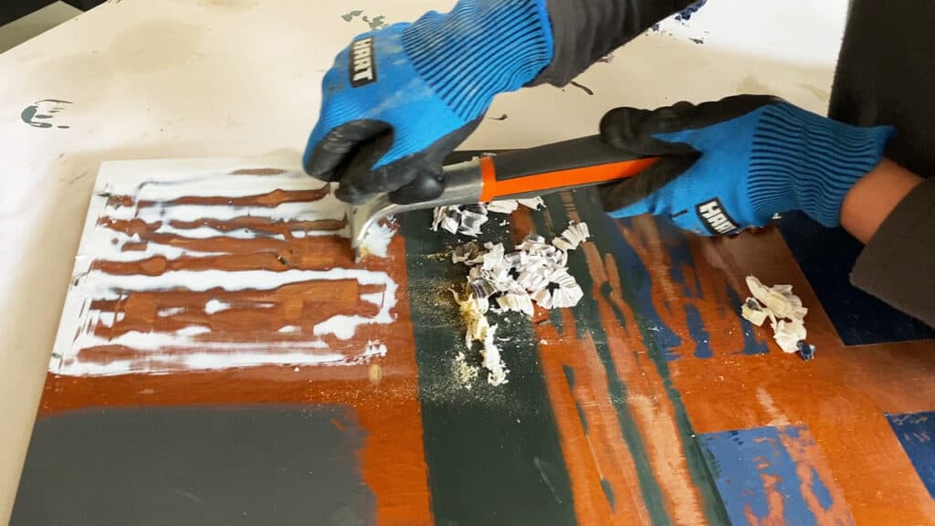 scraping off paint from wood using a carbide scraper