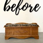 A wooden cedar chest with a floral cushion