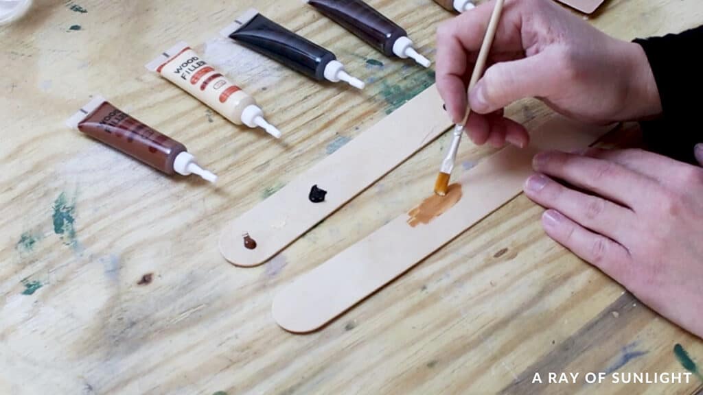 blending paint on popsicle sticks to match wood color