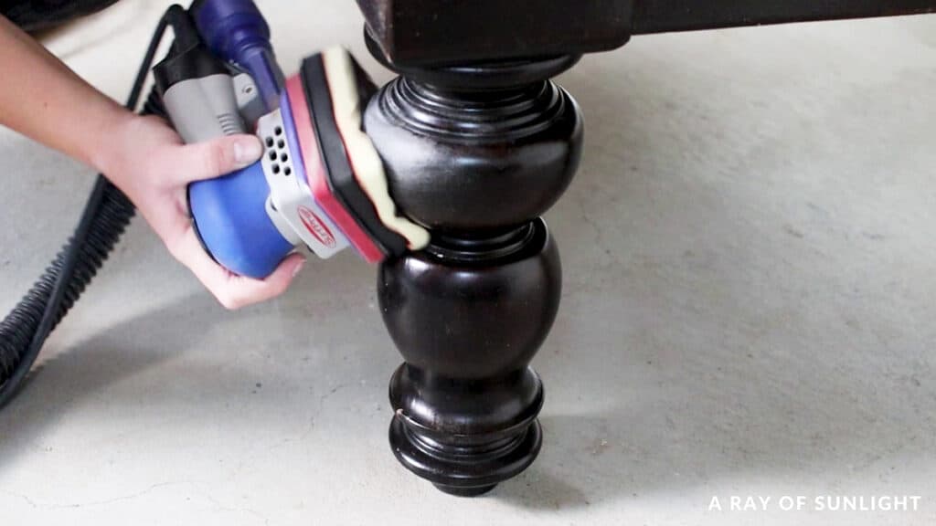 scuff sanding coffee table leg with a power sander