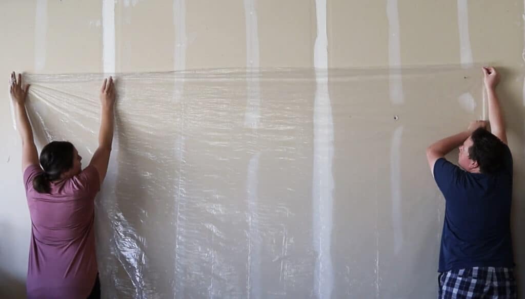 hanging plastic sheet on wall in a garage