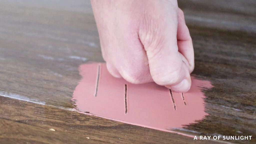 scratching off chalk paint on furniture with fingernail
