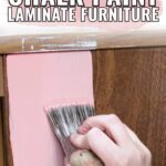 Hand painting pink chalk paint onto brown laminate furniture; text reads, How to Chalk Paint Laminate Furniture.