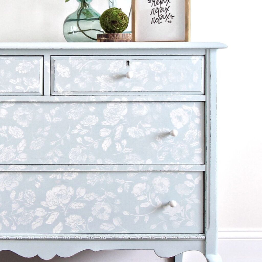 Closeup of light blue dresser painted with stencil