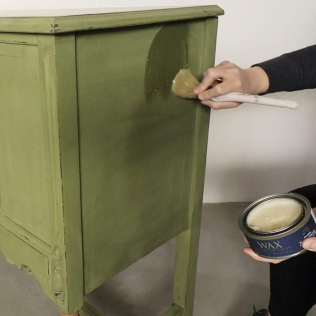 applying wax on the side of chalk painted furniture