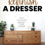 Light stained Wood dresser with plants as a decor on top and brass handles